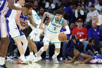Oct 25, 2025; Philadelphia, Pennsylvania, USA; Charlotte Hornets guard LaMelo Ball (1) controls the ball between Philadelphia 76ers guard Tyrese Maxey (0) and guard Kelly Oubre Jr. (9) during the fourth quarter at Xfinity Mobile Arena. Mandatory Credit: Bill Streicher-Imagn Images