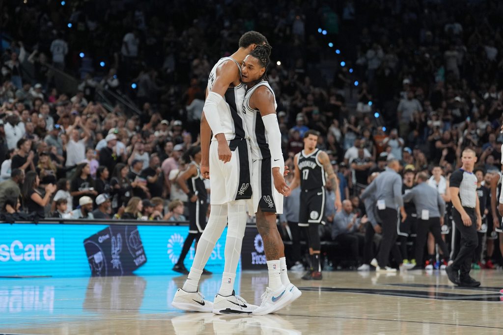 Oct 26, 2025; San Antonio, Texas, USA; San Antonio Spurs forward Victor Wembanyama (1) and San Antonio Spurs guard Devin Vassell (24) celebrate in the second half against the Brooklyn Nets at Frost Bank Center. Mandatory Credit: Daniel Dunn-Imagn Images