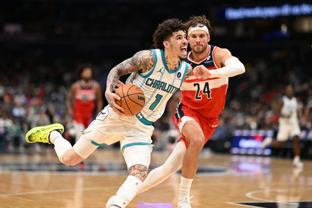Oct 26, 2025; Washington, District of Columbia, USA; Charlotte Hornets guard LaMelo Ball (1) dribbles past Washington Wizards forward Corey Kispert (24) during the third quarter at Capital One Arena. Mandatory Credit: Rafael Suanes-Imagn Images