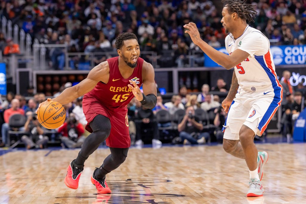 Oct 27, 2025; Detroit, Michigan, USA; Detroit Pistons forward Ronald Holland II (5) defends against Cleveland Cavaliers guard Donovan Mitchell (45) during the second half at Little Caesars Arena. Mandatory Credit: David Reginek-Imagn Images