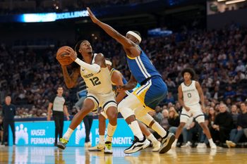 Oct 27, 2025; San Francisco, California, USA; Memphis Grizzlies guard Ja Morant (12) holds onto the ball next to Golden State Warriors forward Jimmy Butler III (10) in the second quarter at the Chase Center. Mandatory Credit: Cary Edmondson-Imagn Images