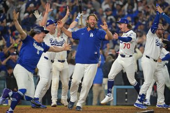 Oct 27, 2025; Los Angeles, California, USA; Los Angeles Dodgers pitcher Clayton Kershaw (22) celebrates with teammates after first baseman Freddie Freeman (5) hit a walk off home run against the Toronto Blue Jays in the eighteenth inning during game three of the 2025 MLB World Series at Dodger Stadium. Mandatory Credit: Jayne Kamin-Oncea-Imagn Images