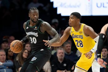 Oct 29, 2025; Minneapolis, Minnesota, USA; Minnesota Timberwolves forward Julius Randle (30) dribbles as Los Angeles Lakers forward Rui Hachimura (28) plays defense in the second half at Target Center. Mandatory Credit: Jesse Johnson-Imagn Images