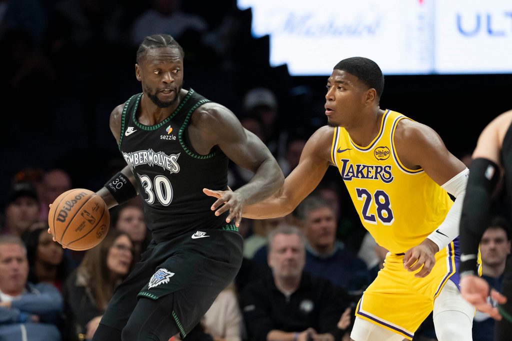 Oct 29, 2025; Minneapolis, Minnesota, USA; Minnesota Timberwolves forward Julius Randle (30) dribbles as Los Angeles Lakers forward Rui Hachimura (28) plays defense in the second half at Target Center. Mandatory Credit: Jesse Johnson-Imagn Images
