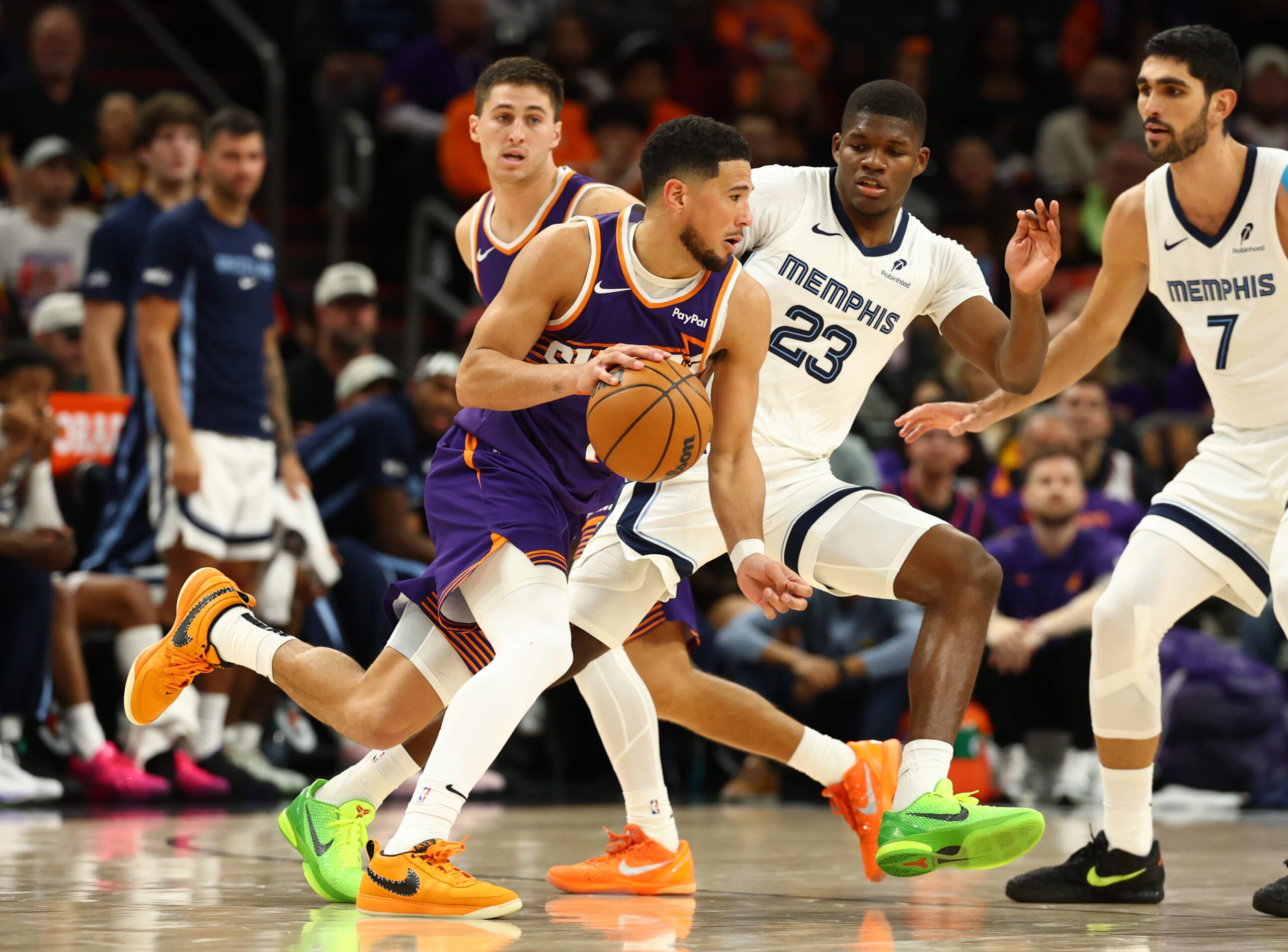 Oct 29, 2025; Phoenix, Arizona, USA; Phoenix Suns guard Devin Booker (1) moves the ball against Memphis Grizzlies forward Cedric Coward (23) during the second half at the Mortgage Matchup Center. Mandatory Credit: Mark J. Rebilas-Imagn Images