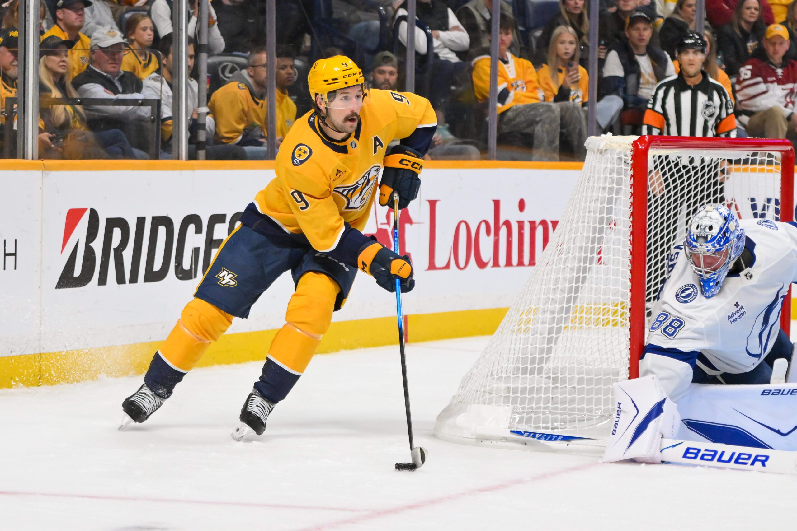 Oct 28, 2025; Nashville, Tennessee, USA;  Nashville Predators left wing Filip Forsberg (9) skates behind the net against the Tampa Bay Lightning during the third period at Bridgestone Arena. Mandatory Credit: Steve Roberts-Imagn Images