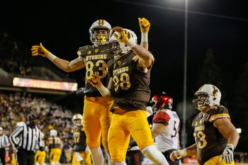 Dec 3, 2016; Laramie, WY, USA; Wyoming Cowboys tight end Jacob Hollister (88) and Jake Maulhardt (83) celebrate a touchdown against San Diego State Aztecs safety Malik Smith (12) during the first quarter at the Mountain West Championship college football game at War Memorial Stadium. Mandatory Credit: Troy Babbitt-Imagn Images