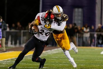 Dec 3, 2016; Laramie, WY, USA; San Diego State Aztecs running back Rashaad Penny (20) is tackled by Wyoming Cowboys cornerback Antonio Hull (21) during the second quarter at the Mountain West Championship college football game at War Memorial Stadium. Mandatory Credit: Troy Babbitt-Imagn Images