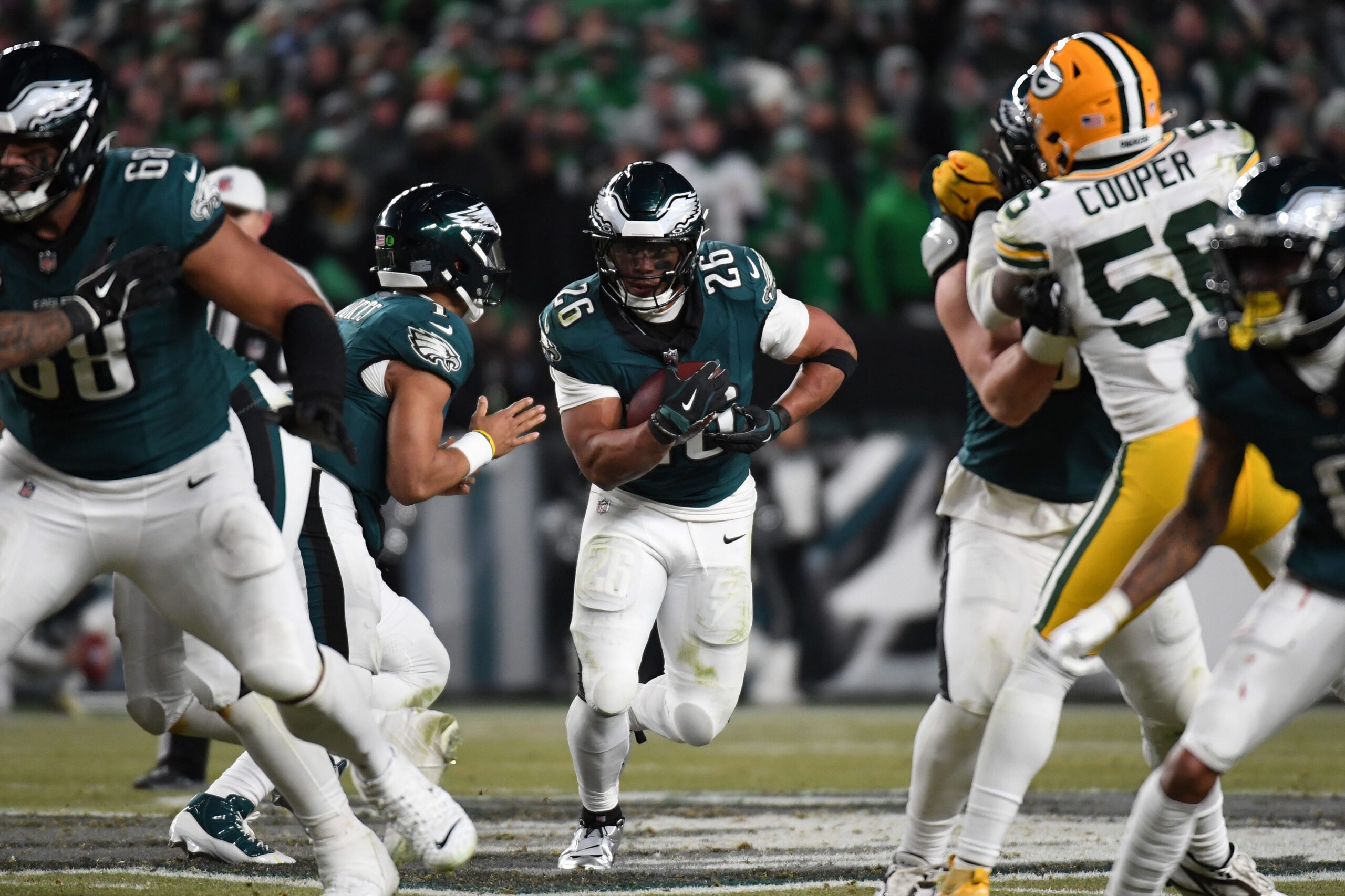 Jan 12, 2025; Philadelphia, Pennsylvania, USA; Philadelphia Eagles running back Saquon Barkley (26) rushes the ball against the Green Bay Packers during the second half in an NFC wild card game at Lincoln Financial Field. Mandatory Credit: Eric Hartline-Imagn Images