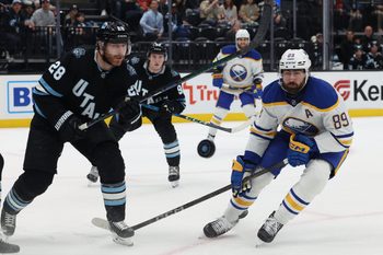 Mar 20, 2025; Salt Lake City, Utah, USA; Utah Hockey Club defenseman Ian Cole (28) and Buffalo Sabres right wing Alex Tuch (89) watch the puck during the third period at Delta Center. Mandatory Credit: Rob Gray-Imagn Images
