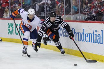 Apr 13, 2025; Newark, New Jersey, USA; New Jersey Devils defenseman Simon Nemec (17) and New York Islanders left wing Pierre Engvall (18) battle for the puck during the third period at Prudential Center. Mandatory Credit: Ed Mulholland-Imagn Images