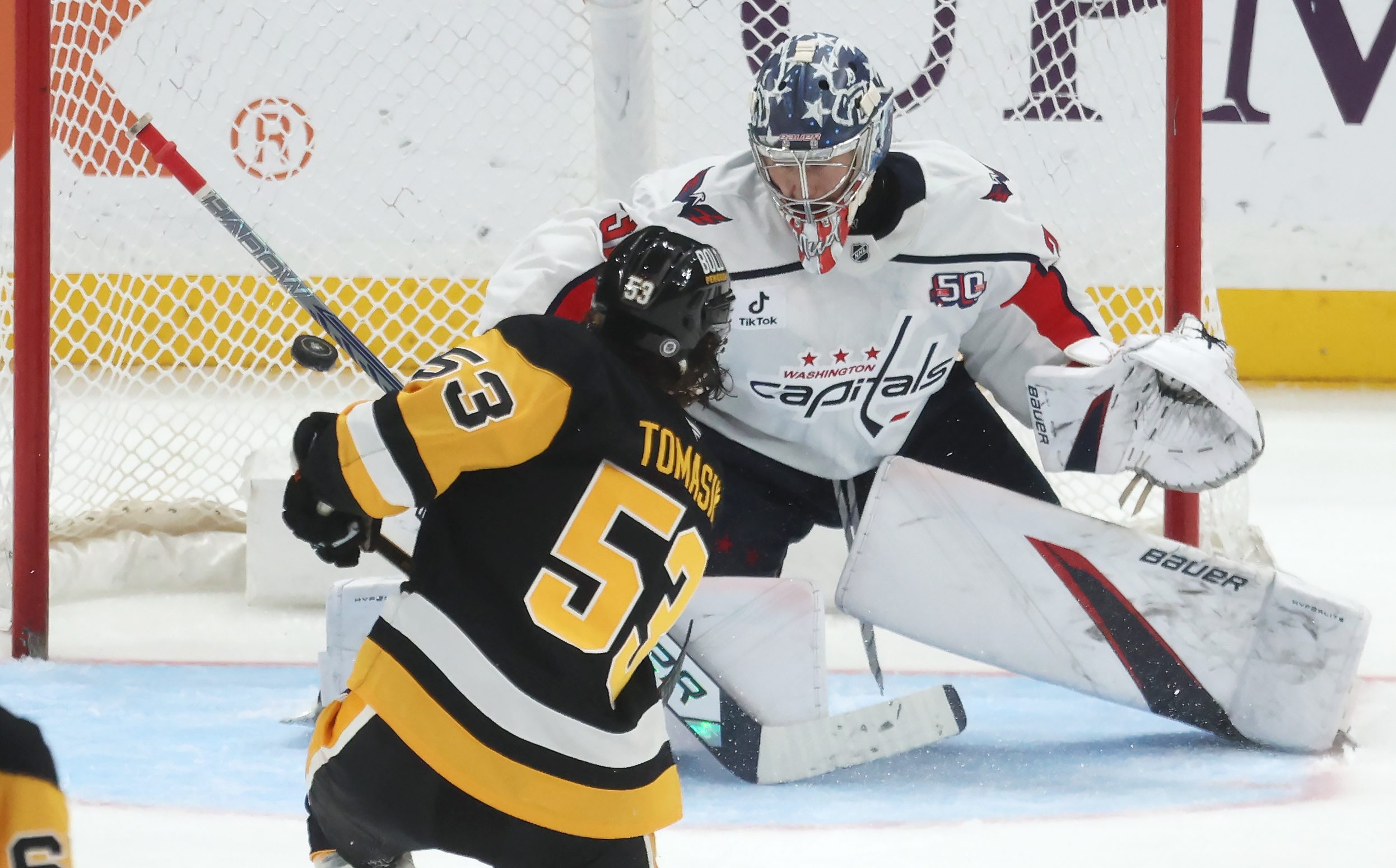 Apr 17, 2025; Pittsburgh, Pennsylvania, USA;  Pittsburgh Penguins center Philip Tomasino (53) scores a goal past Washington Capitals goaltender Clay Stevenson (33) during the third period at PPG Paints Arena. Mandatory Credit: Charles LeClaire-Imagn Images