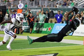 Oct 11, 2025; Honolulu, Hawaii, USA;  Hawaii Rainbow Warriors wide receiver Pofele Ashlock (5) pulls in a touchdown catch over Utah State Aggies safety Bobby Arnold (12) during the first half at Clarence T.C. Ching Athletics Complex. Mandatory Credit: Marco Garcia-Imagn Images