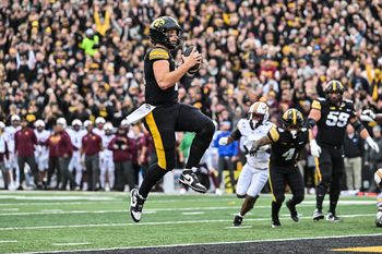 Oct 25, 2025; Iowa City, Iowa, USA; Iowa Hawkeyes quarterback Mark Gronowski (11) runs for a touchdown during the first quarter against the Minnesota Golden Gophers at Kinnick Stadium. Mandatory Credit: Jeffrey Becker-Imagn Images