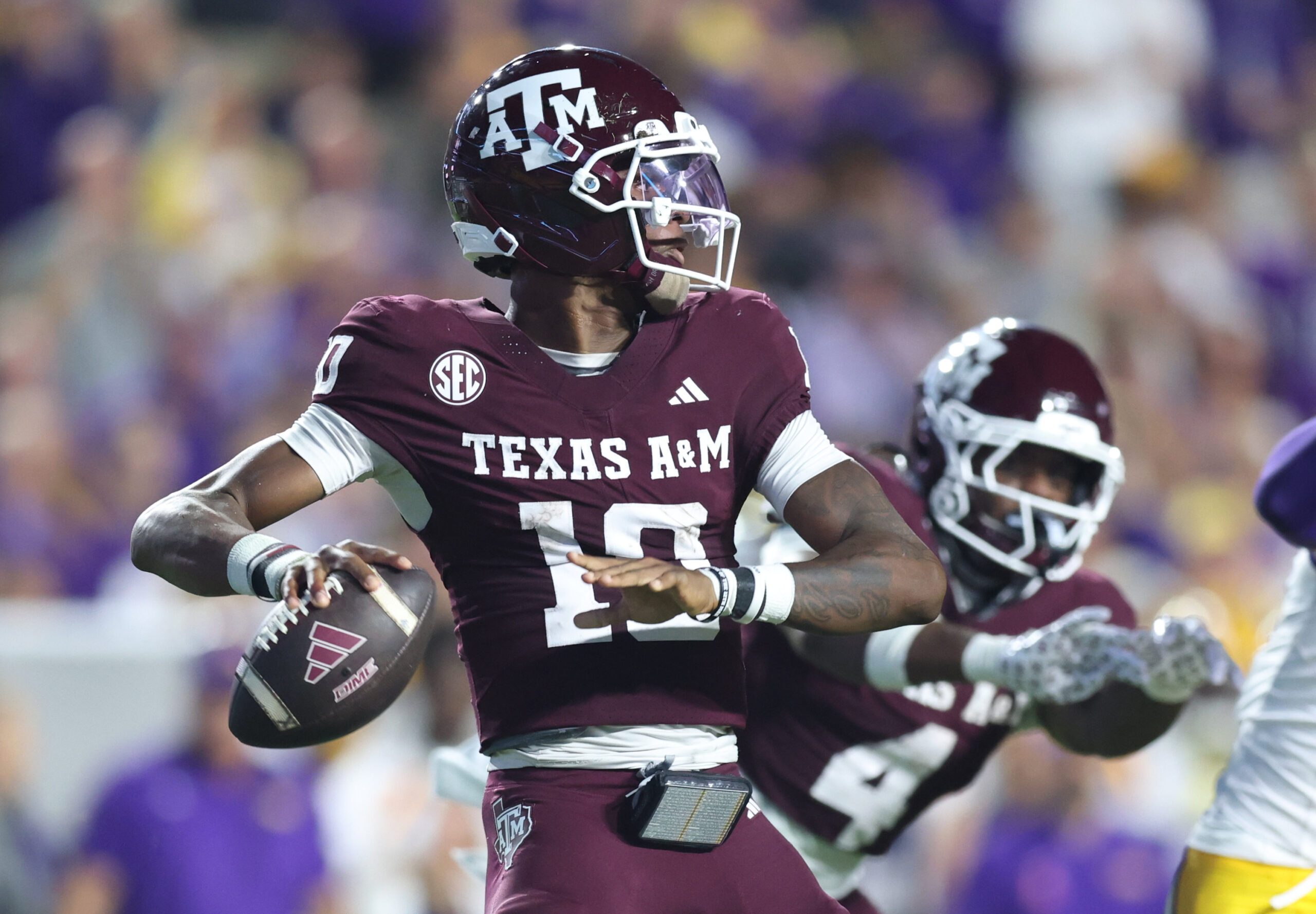 Oct 25, 2025; Baton Rouge, Louisiana, USA; Texas A&M Aggies quarterback Marcel Reed (10) drops to throw during the first half against the Louisiana State Tigers at Tiger Stadium. Mandatory Credit: Stephen Lew-Imagn Images