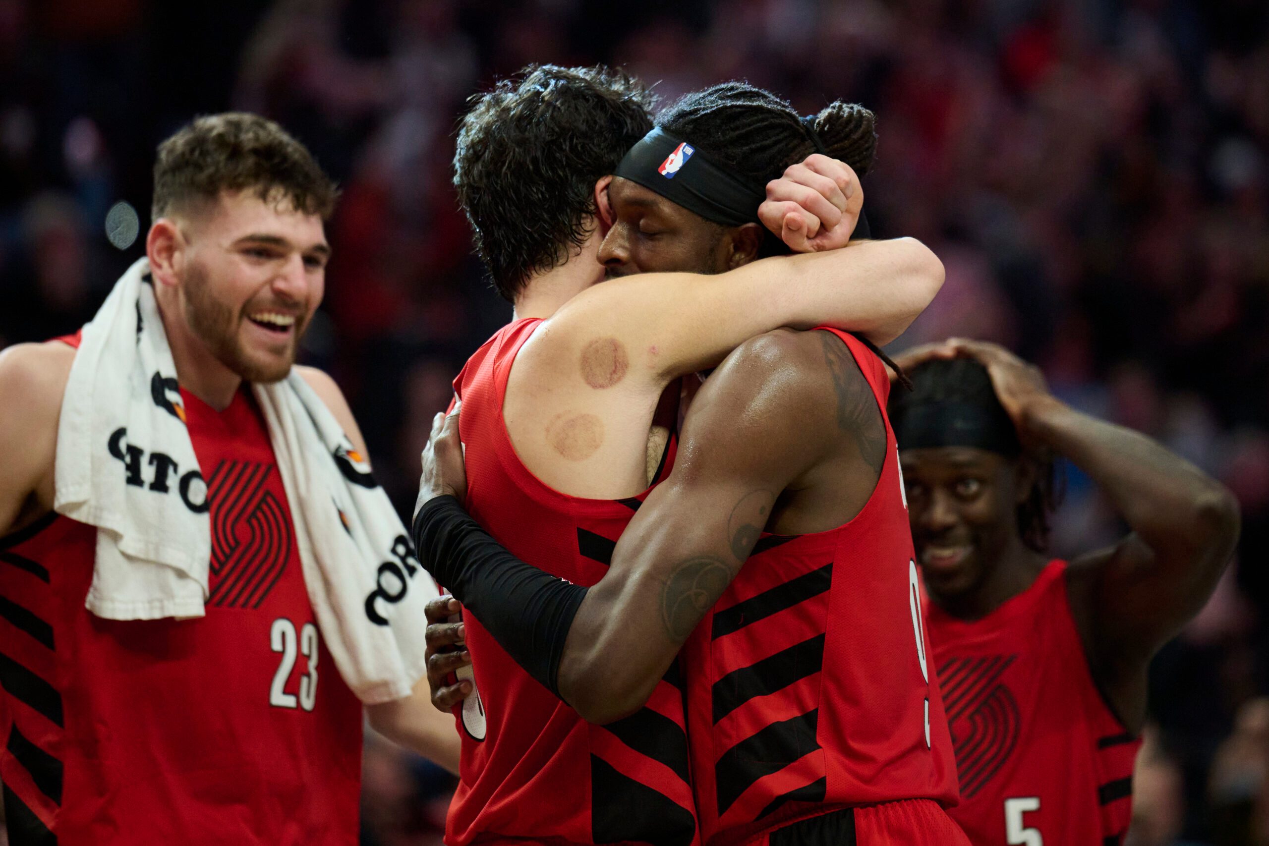 Oct 31, 2025; Portland, Oregon, USA; Portland Trail Blazers forward Jerami Grant (9), right, celebrates with forward Deni Avdija (8) after a game against the Denver Nuggets at Moda Center. Grant scored the game winning free throws. Mandatory Credit: Troy Wayrynen-Imagn Images