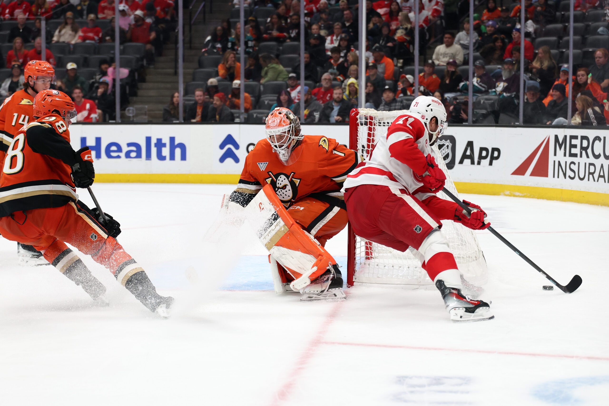 Oct 31, 2025; Anaheim, California, USA;  Detroit Red Wings center Dylan Larkin (71) controls the puck against Anaheim Ducks goaltender Lukas Dostal (1) during the third period at Honda Center. Mandatory Credit: Kiyoshi Mio-Imagn Images