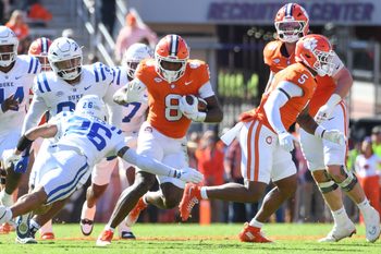 Nov 1, 2025; Clemson, South Carolina, USA; Duke Blue Devils safety Ma'Khi Jones (26) goes to tackle Clemson Tigers running back Adam Randall (8) during the game at Memorial Stadium. Mandatory Credit: Alex Martin-Imagn Images
