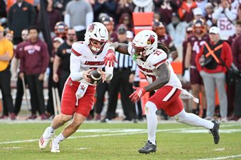 Nov 1, 2025; Blacksburg, Virginia, USA; Louisville Cardinals quarterback Miller Moss (7) hands the ball off to Louisville Cardinals running back Keyjuan Brown (22) during the fourth quarter at Lane Stadium. Mandatory Credit: Brian Bishop-Imagn Images