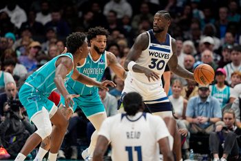 Nov 1, 2025; Charlotte, North Carolina, USA; Minnesota Timberwolves forward Julius Randle (30) looks to pass against Charlotte Hornets forward Miles Bridges (0) and forward Moussa Diabate (14) during the second quarter at Spectrum Center. Mandatory Credit: Jim Dedmon-Imagn Images