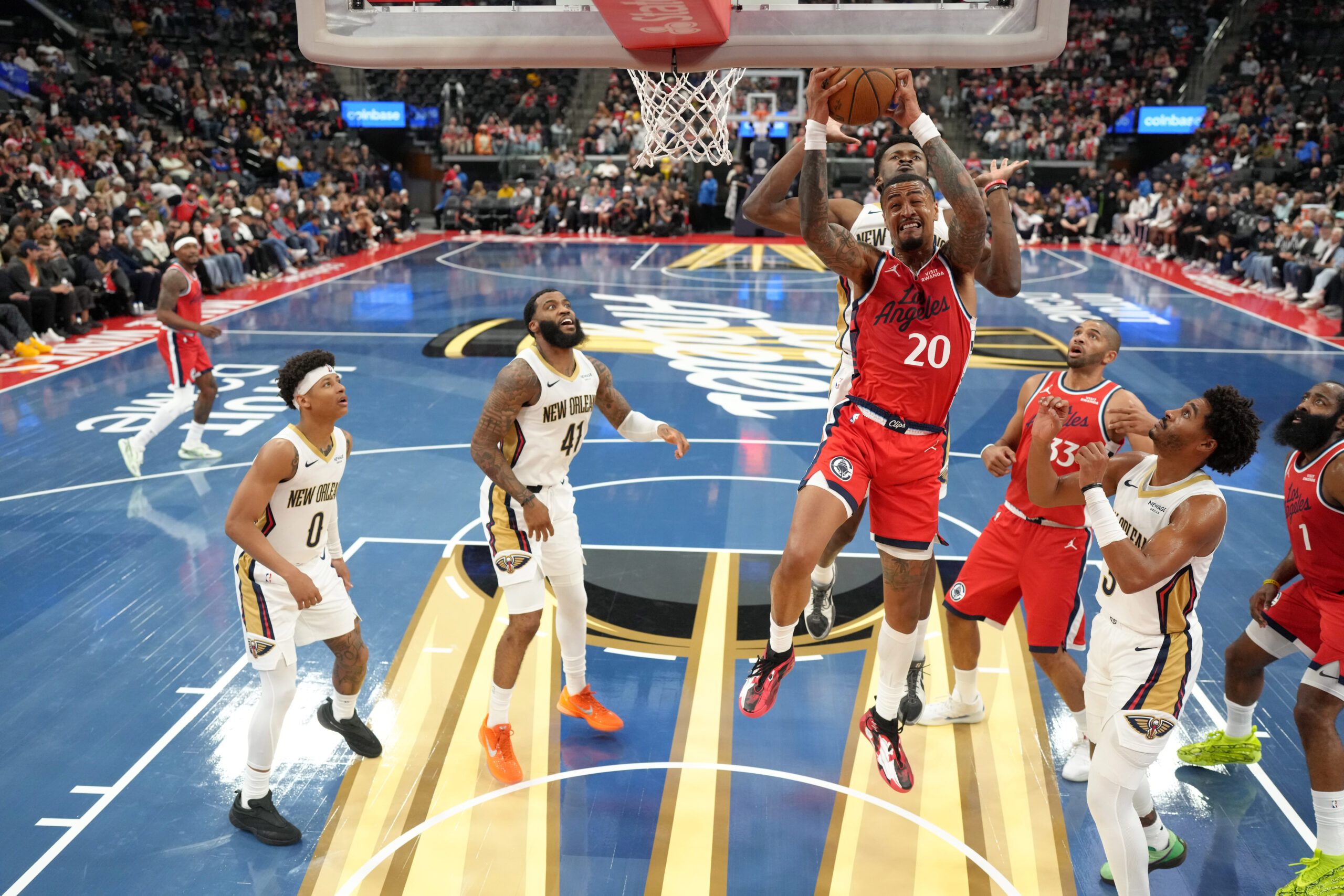 Oct 31, 2025; Inglewood, California, USA; LA Clippers forward John Collins (20) rebounds the ball against New Orleans Pelicans guard Jeremiah Fears (0), guard Saddiq Bey (41), forward Zion Williamson (1) and guard Jordan Poole (3) at Intuit Dome. Mandatory Credit: Kirby Lee-Imagn Images