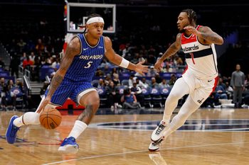 Nov 1, 2025; Washington, District of Columbia, USA; Orlando Magic forward Paolo Banchero (5) drives to the basket as Washington Wizards forward Cam Whitmore (1) defends in the first half at Capital One Arena. Mandatory Credit: Geoff Burke-Imagn Images
