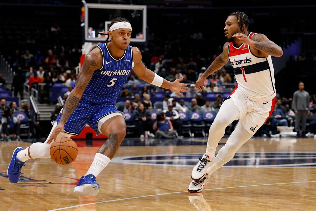 Nov 1, 2025; Washington, District of Columbia, USA; Orlando Magic forward Paolo Banchero (5) drives to the basket as Washington Wizards forward Cam Whitmore (1) defends in the first half at Capital One Arena. Mandatory Credit: Geoff Burke-Imagn Images
