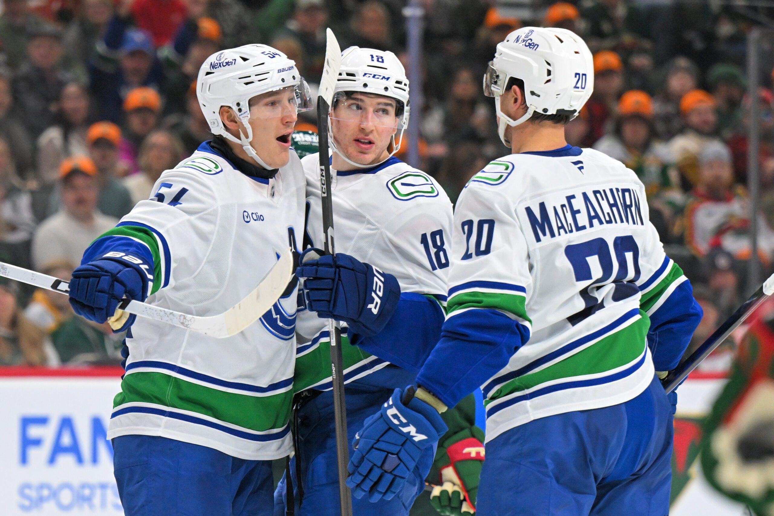 Nov 1, 2025; Saint Paul, Minnesota, USA;  Vancouver Canucks forward Drew O'Connor (18) celebrates his goal against the Minnesota Wild with forward Aatu Raty (54) and forward Mackenzie MacEachern during the third period at Grand Casino Arena. Mandatory Credit: Nick Wosika-Imagn Images