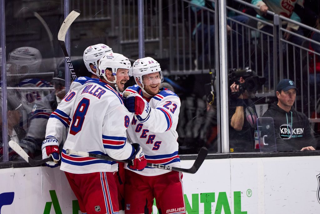 Nov 1, 2025; Seattle, Washington, USA; New York Rangers left wing Will Cuylle (50), New York Rangers defenseman Adam Fox (23), and New York Rangers center J.T. Miller (8) celebrate an overtime win against the Seattle Kraken at Climate Pledge Arena. Mandatory Credit: Blake Dahlin-Imagn Images
