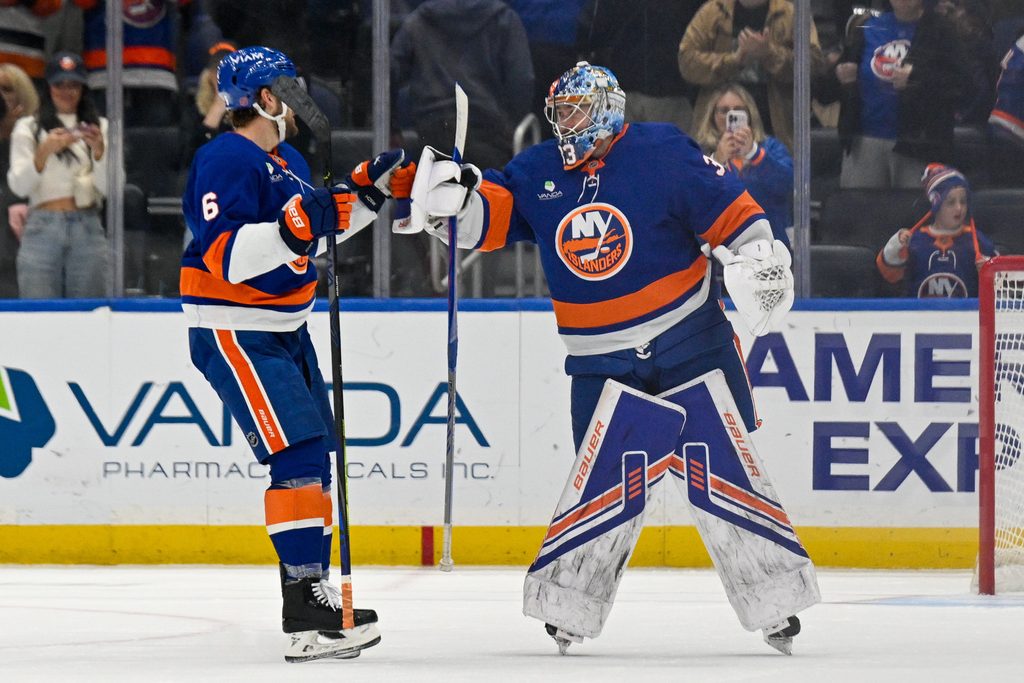 Nov 2, 2025; Elmont, New York, USA; New York Islanders defenseman Ryan Pulock (6) celebrates the 3-2 victory with goaltender David Rittich (33) against the Columbus Blue Jackets during the third period at UBS Arena. Mandatory Credit: Dennis Schneidler-Imagn Images