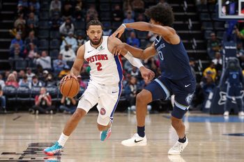 Nov 3, 2025; Memphis, Tennessee, USA; Detroit Pistons guard Cade Cunningham (2) dribbles as Memphis Grizzlies forward Jaylen Wells (0) during the first quarter at FedExForum. Mandatory Credit: Petre Thomas-Imagn Images
