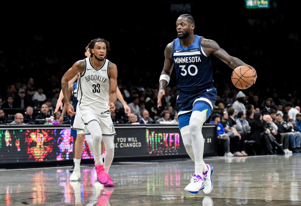 Nov 3, 2025; Brooklyn, New York, USA; Minnesota Timberwolves forward Julius Randle (30) looks to drive against Brooklyn Nets center Nic Claxton (33) during the first half at Barclays Center. Mandatory Credit: John Jones-Imagn Images
