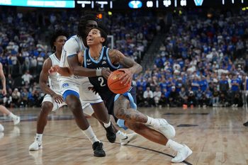 Nov 3, 2025; Las Vegas, Nevada, USA; Villanova Wildcats guard Bryce Lindsay (2) is fouled by BYU Cougars forward Khadim Mboup (7) during the second half of the Hall of Fame Series game at T-Mobile Arena. Mandatory Credit: Candice Ward-Imagn Images