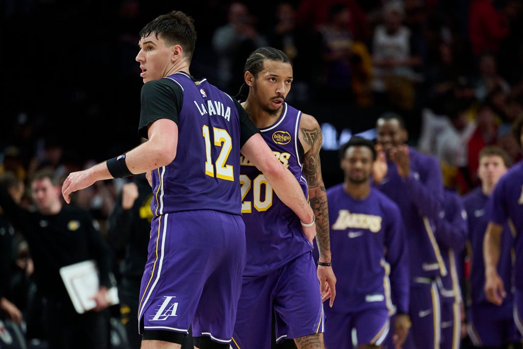 Nov 3, 2025; Portland, Oregon, USA; Los Angeles Lakers guard Nick Smith Jr. (20) celebrates with teammate forward Jake LaRavia (12) after a game against the Portland Trail Blazers at Moda Center. Mandatory Credit: Troy Wayrynen-Imagn Images