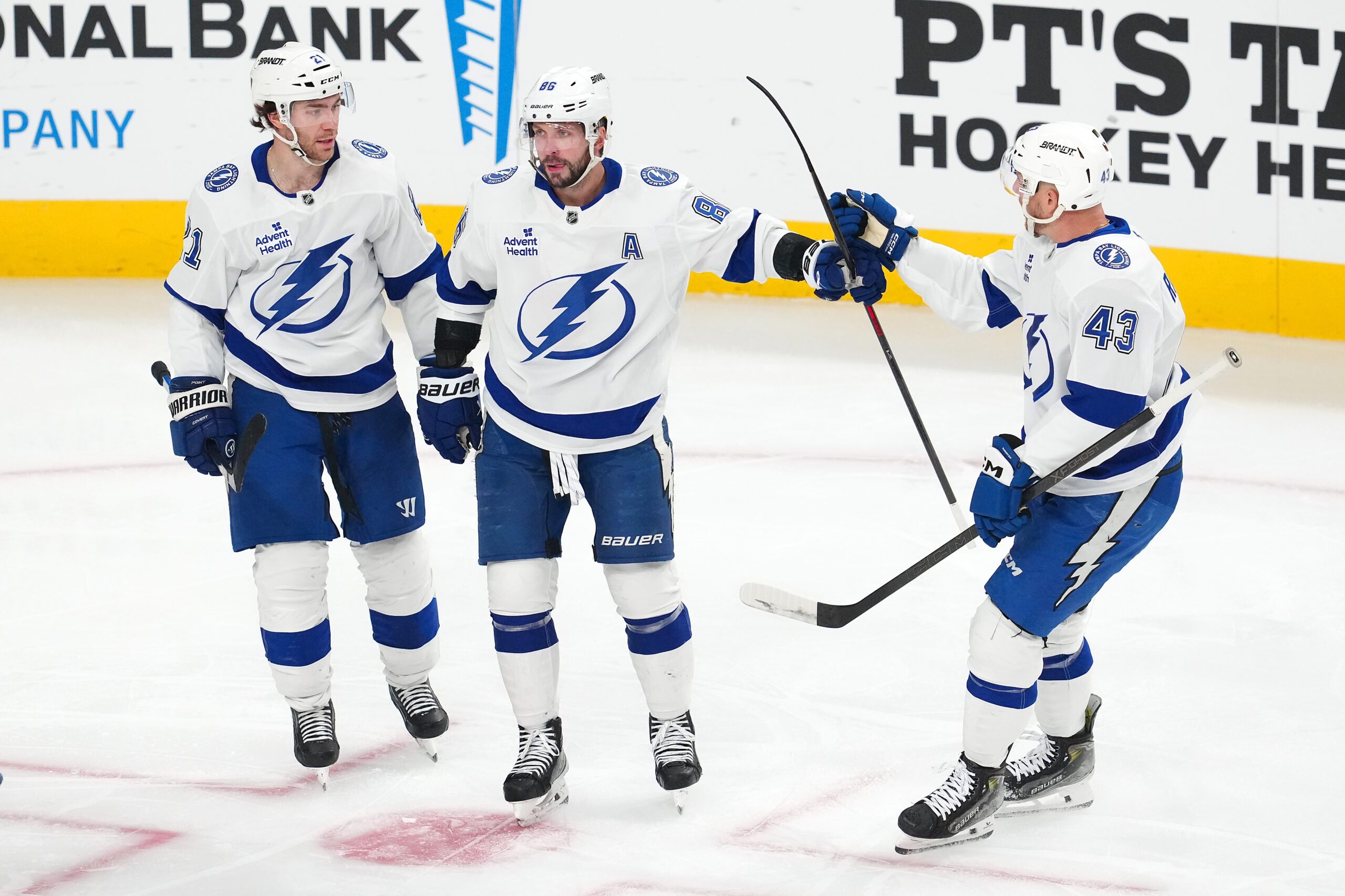 Nov 6, 2025; Las Vegas, Nevada, USA; Tampa Bay Lightning right wing Nikita Kucherov (86) celebrates with center Brayden Point (21) and defenseman Darren Raddysh (43) after scoring a goal against the Vegas Golden Knights during the third period at T-Mobile Arena. Mandatory Credit: Stephen R. Sylvanie-Imagn Images