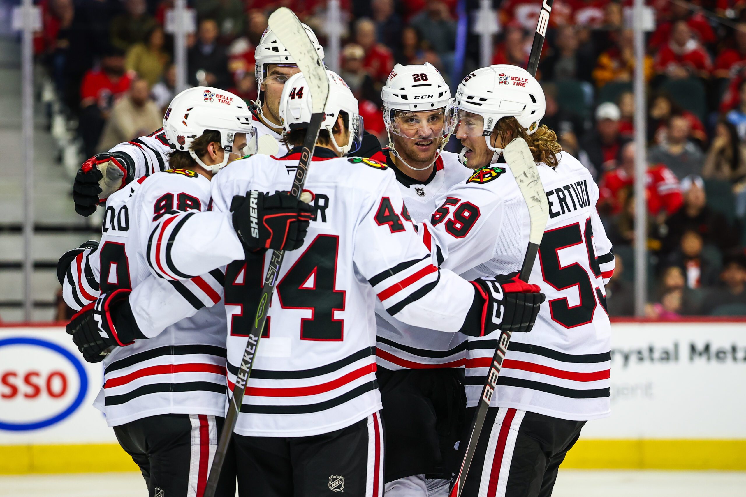 Nov 7, 2025; Calgary, Alberta, CAN; Chicago Blackhawks left wing Andre Burakovsky (28) celebrates his goal with teammates against the Calgary Flames during the third period at Scotiabank Saddledome. Mandatory Credit: Sergei Belski-Imagn Images
