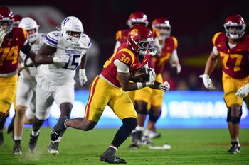 Nov 7, 2025; Los Angeles, California, USA; Southern California Trojans running back King Miller (30) runs the ball against the Northwestern Wildcats during the second half at the Los Angeles Memorial Coliseum. Mandatory Credit: Gary A. Vasquez-Imagn Images