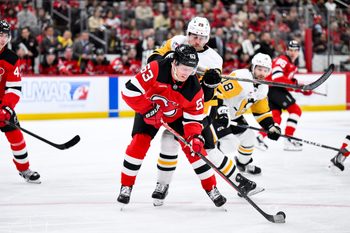 Nov 8, 2025; Newark, New Jersey, USA; New Jersey Devils left wing Jesper Bratt (63) skates with the puck while defended by Pittsburgh Penguins defenseman Parker Wotherspoon (28) during the first period at Prudential Center. Mandatory Credit: John Jones-Imagn Images