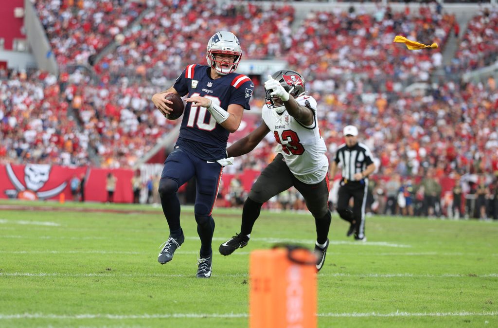 Nov 9, 2025; Tampa, Florida, USA; New England Patriots quarterback Drake Maye (10) runs for a gain past Tampa Bay Buccaneers safety Tykee Smith (23) during the fourth quarter at Raymond James Stadium. Mandatory Credit: Nathan Ray Seebeck-Imagn Images