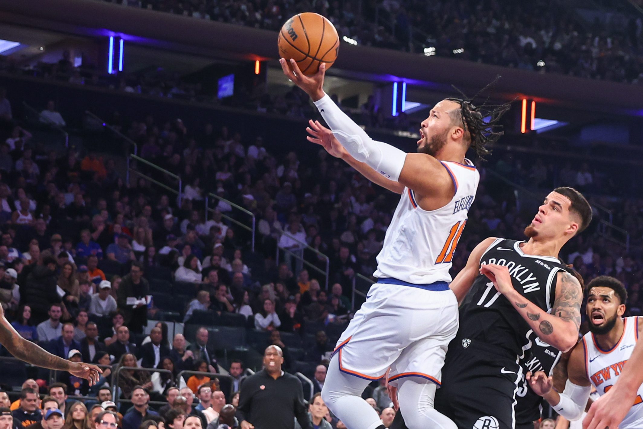 Nov 9, 2025; New York, New York, USA;  New York Knicks guard Jalen Brunson (11) drives past Brooklyn Nets forward Michael Porter Jr. (17) in the first quarter at Madison Square Garden. Mandatory Credit: Wendell Cruz-Imagn Images