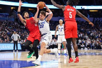 Nov 10, 2025; Orlando, Florida, USA; Orlando Magic forward Franz Wagner (22) drives to the basket past Portland Trail Blazers forward Toumani Camara (33) in the fourth quarter at Kia Center. Mandatory Credit: Nathan Ray Seebeck-Imagn Images