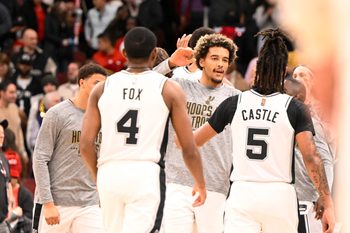 Nov 10, 2025; Chicago, Illinois, USA;  San Antonio Spurs teammates celebrate against the Chicago Bulls during the second half at the United Center. Mandatory Credit: Matt Marton-Imagn Images