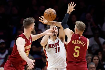 Nov 10, 2025; Miami, Florida, USA;  Cleveland Cavaliers forward Dean Wade (32) and guard Sam Merrill (5) defend Miami Heat forward Jaime Jaquez Jr. (11) during the second half at Kaseya Center. Mandatory Credit: Rhona Wise-Imagn Images