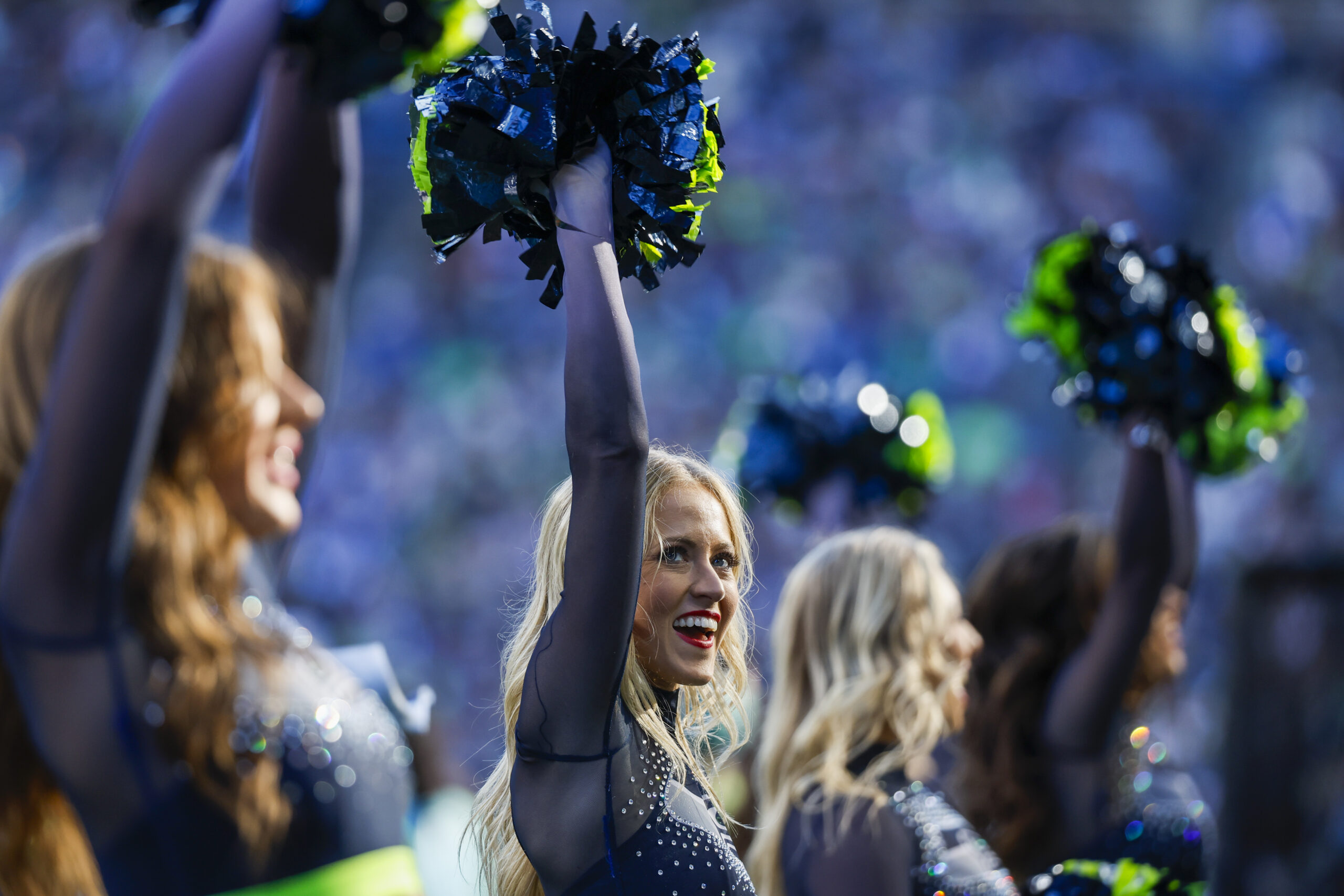 Oct 6, 2024; Seattle, Washington, USA; A Seattle Seahawks cheerleader stands on the sideline during the fourth quarter against the New York Giants at Lumen Field. Mandatory Credit: Joe Nicholson-Imagn Images