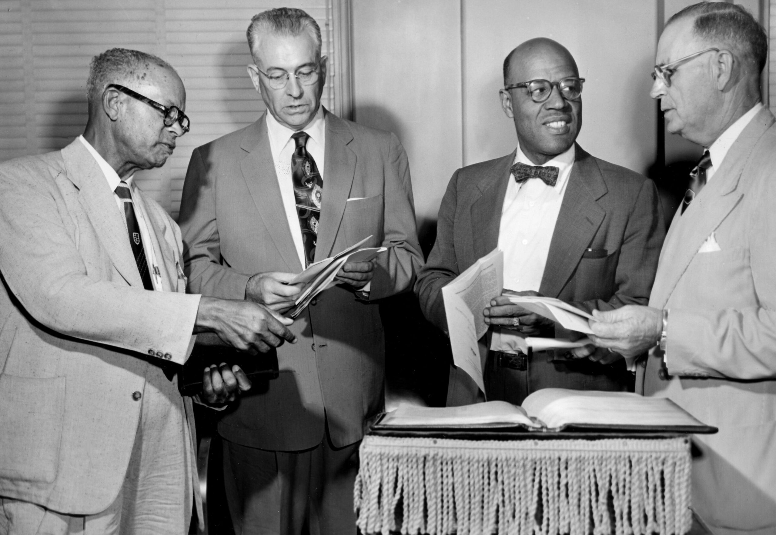 From left, Dr. Herbert L. Lang, Jackson, Miss., president of Mississippi Baptist seminary; Dr. William A. Keel, Jackson, secretary of Black work for the state Baptist Mission Board of Mississippi; Dr. Ralph W. Riley, president of American Baptist director of Black work for the home mission board of the Theological Seminary; and Dr. Guy Bellamy, Oklahoma City, Southern Baptist Convention, share a moment on the opening of the three-day South wide Conference on Black work at the American Baptist Theological Seminary on Sept. 29, 1953.