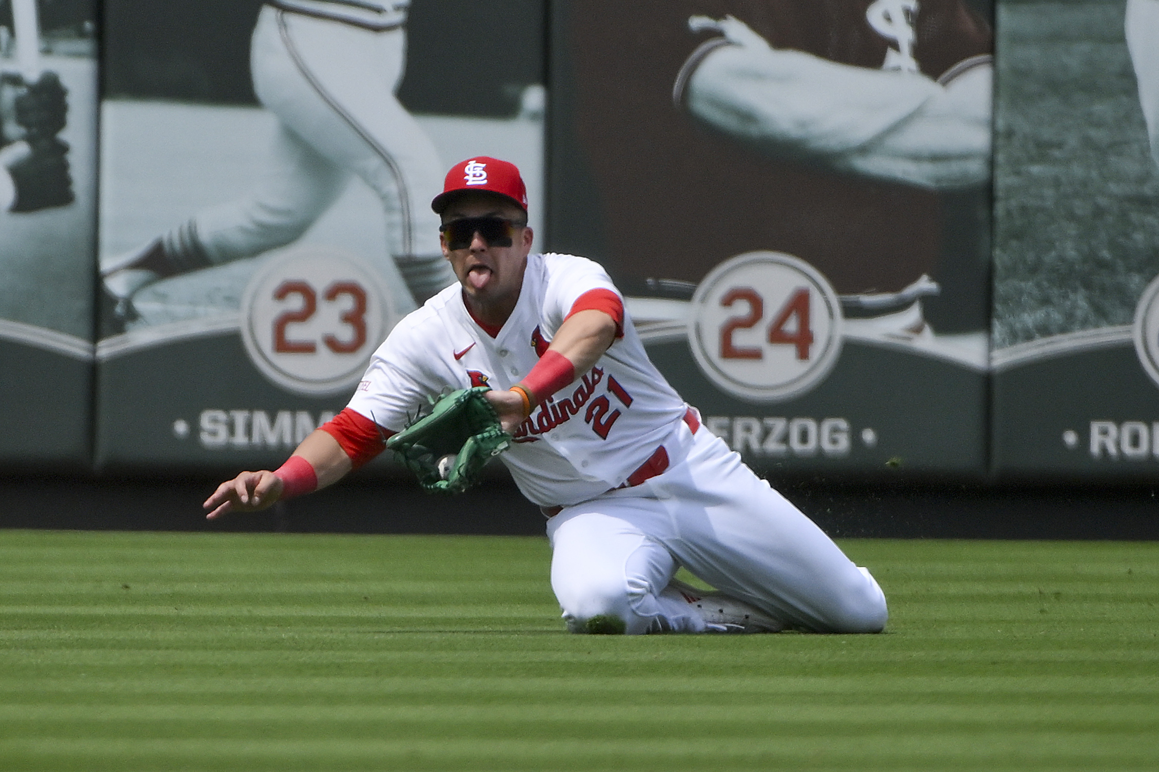 Jun 11, 2025; St. Louis, Missouri, USA;  St. Louis Cardinals left fielder Lars Nootbaar (21) slides and makes a catch against the Toronto Blue Jays during the sixth inning at Busch Stadium. Mandatory Credit: Jeff Curry-Imagn Images