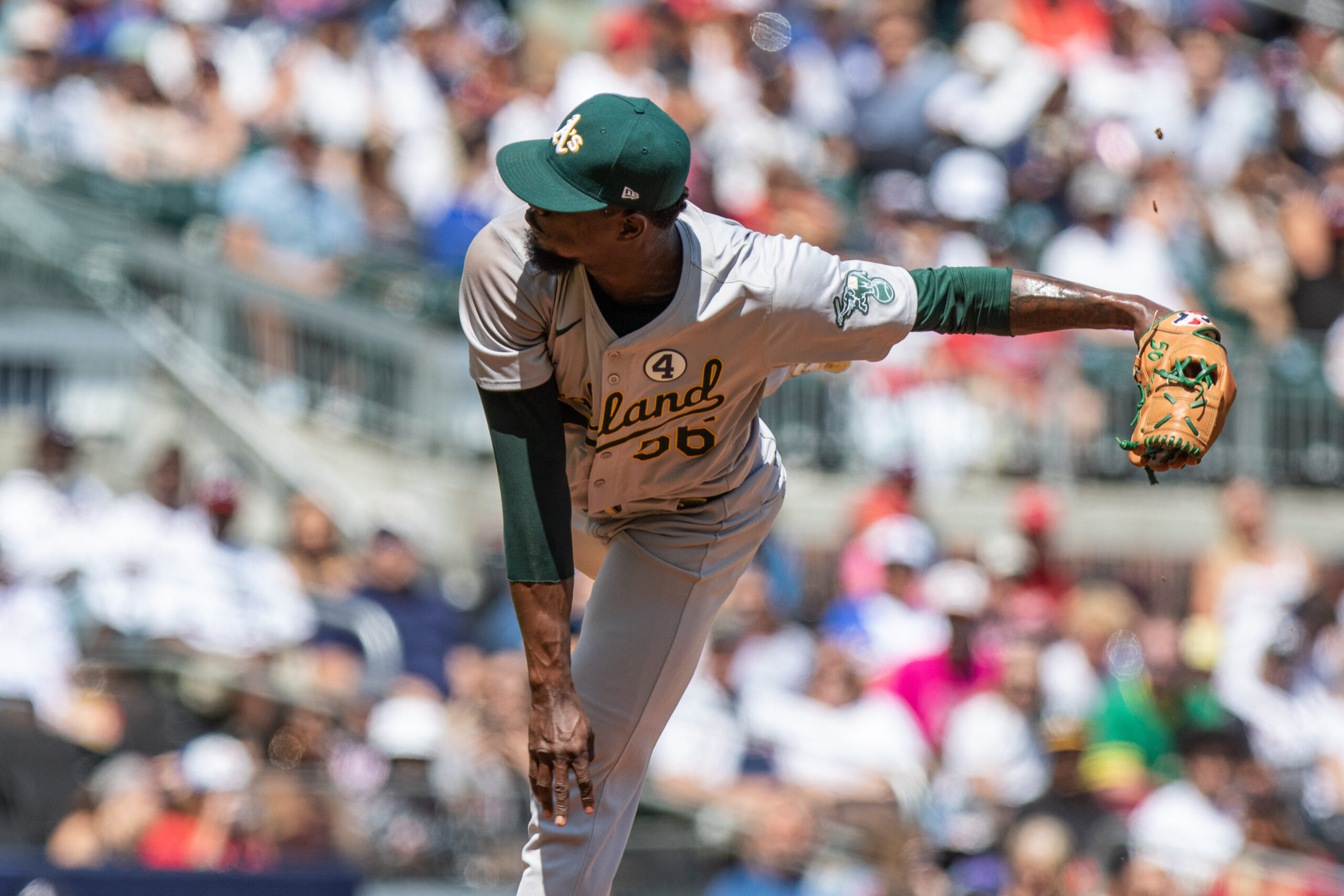 Jun 2, 2024; Cumberland, Georgia, USA;  Oakland Athletics pitcher Dany Jiménez (56) pitches the ball against the Atlanta Braves during the eighth inning at Truist Park. Mandatory Credit: Jordan Godfree-Imagn Images