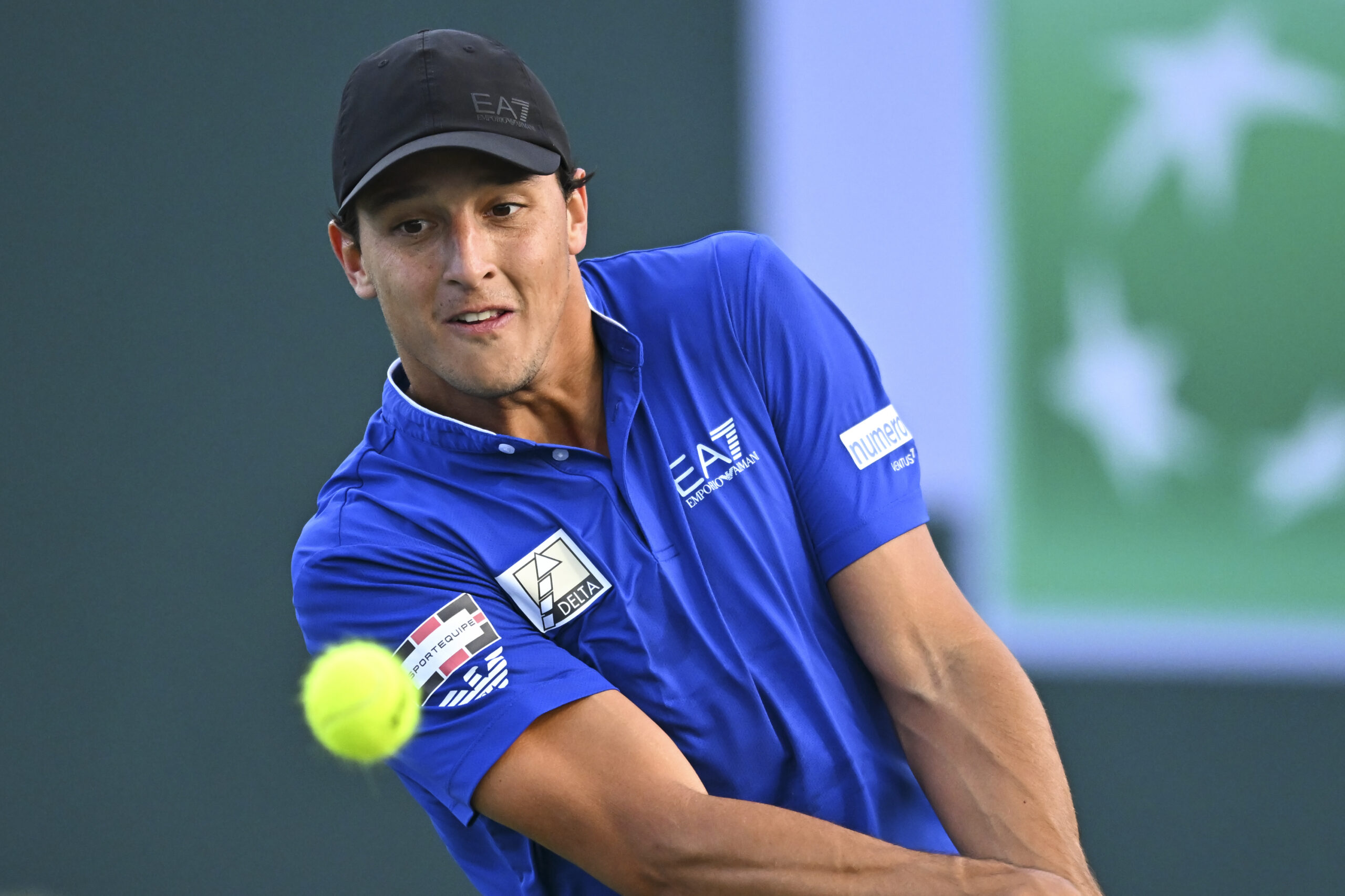 Mar 6, 2025; Indian Wells, CA, USA; Luciano Darderi (ITA) hits a ball against Hugo Gaston (FRA) in the BNP Paribas Open at the Indian Well Tennis Garden. Mandatory Credit: Jonathan Hui-Imagn Images