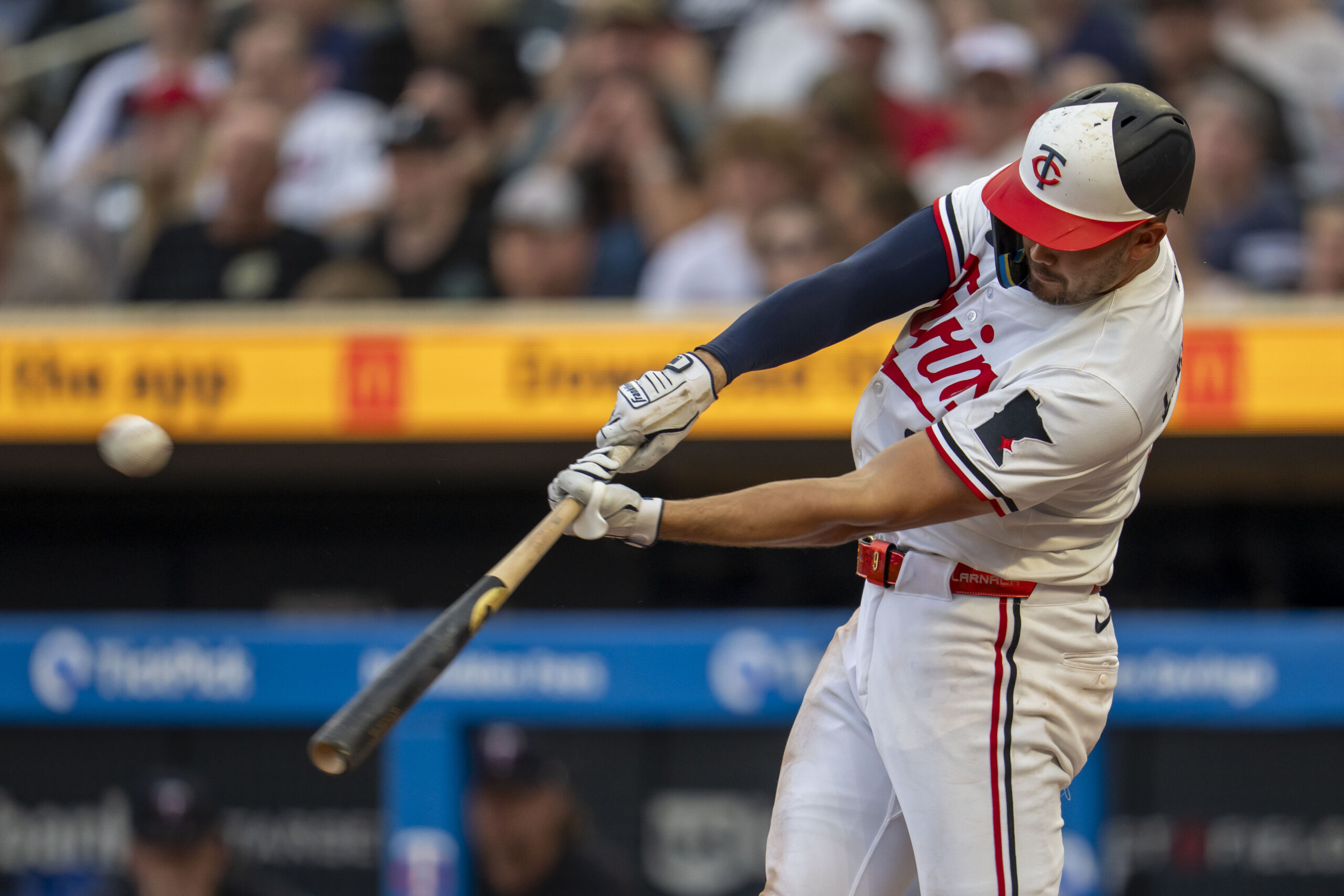 Jun 23, 2025; Minneapolis, Minnesota, USA; Minnesota Twins right fielder Trevor Larnach (9) hits a solo home run against the Seattle Mariners in the sixth inning at Target Field. Mandatory Credit: Jesse Johnson-Imagn Images