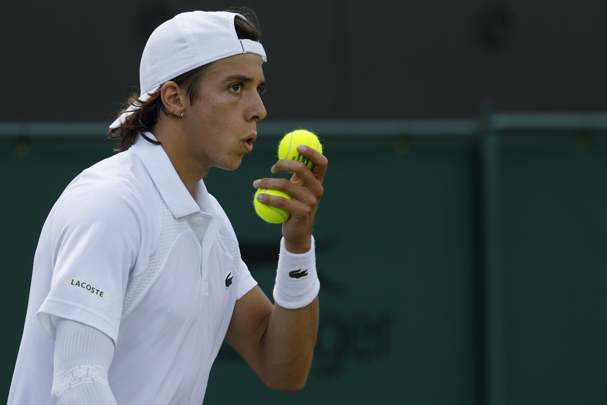 Jul 3, 2025; Wimbledon, United Kingdom; Arthur Cazaux (FRA) blows on his hand prior to serving against Alex de Minaur (AUS)(not pictured) on day four of The Championships Wimbledon 2025 at All England Lawn Tennis and Croquet Club. Mandatory Credit: Geoff Burke-Imagn Images
